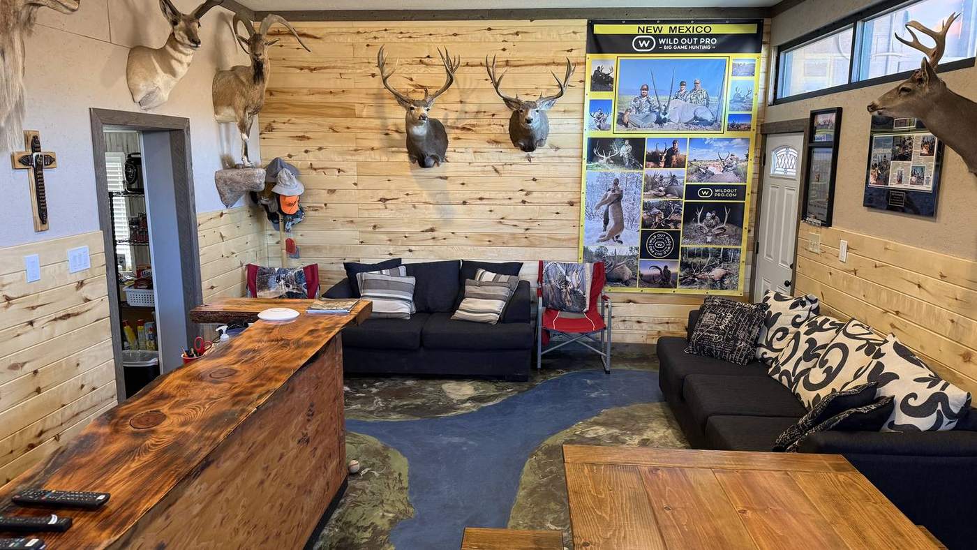 The great room at The Cockhouse Lodge with game mounts and bar, Blanco New Mexico